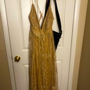 A beige crystal prom dress.Straps, with a thigh cut